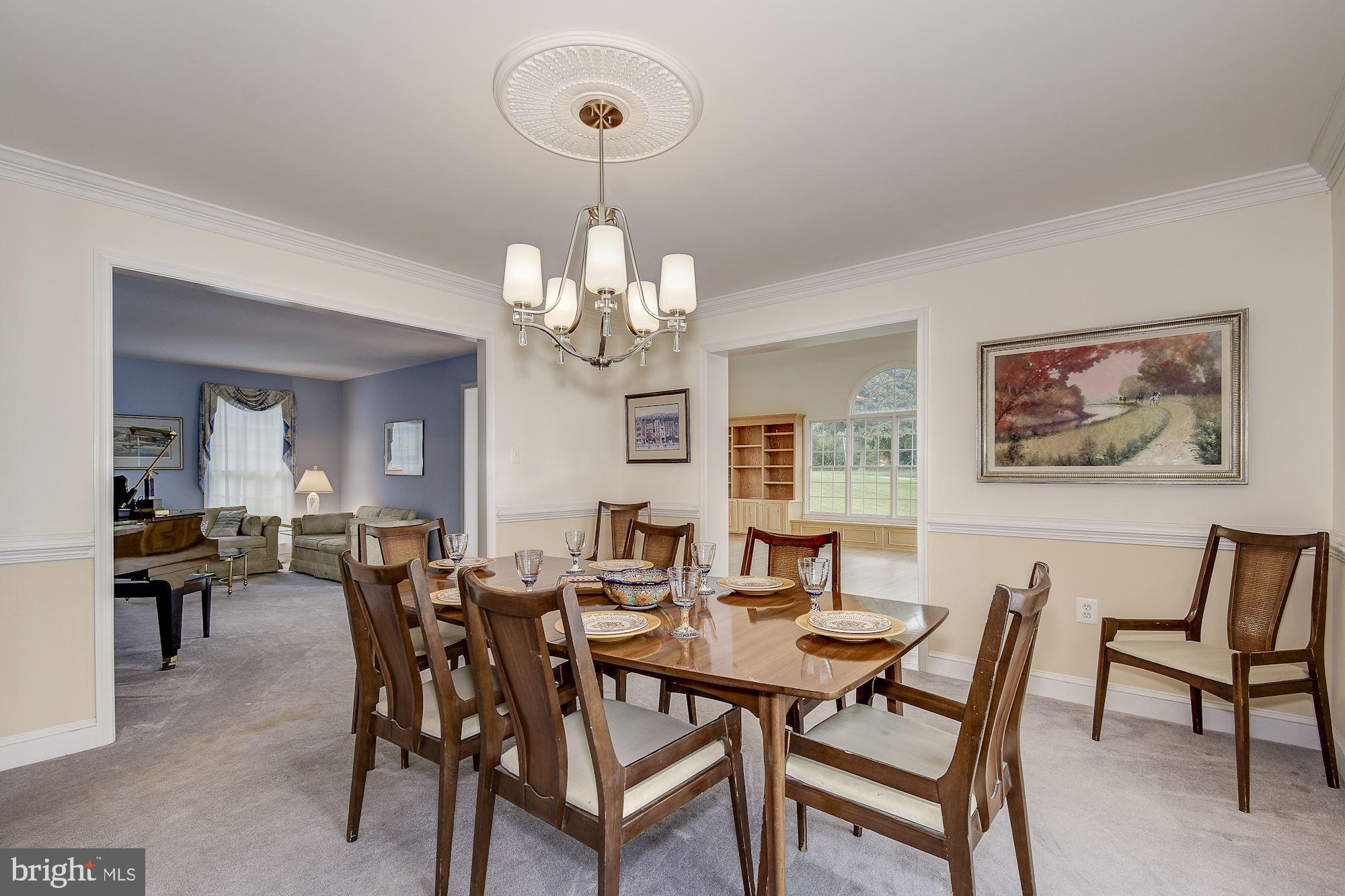 10920 Ward Road Dunkirk, MD 20754 - Photo 13 of 63 a view of a dining room with furniture wooden floor and chandelier