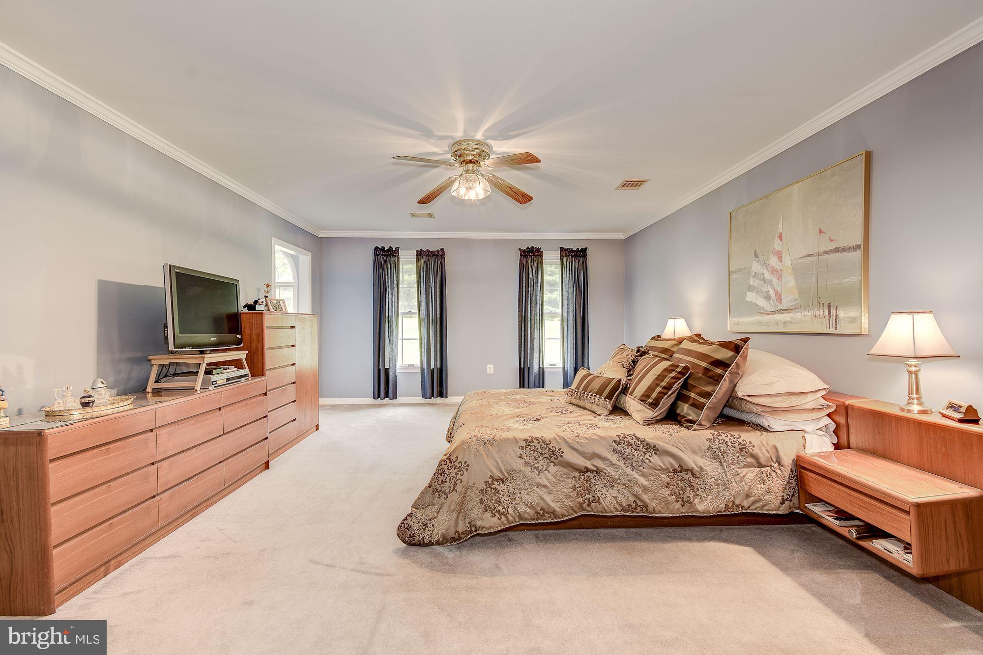 10920 Ward Road Dunkirk, MD 20754 - Photo 25 of 63 a bedroom with a bed and a flat screen tv