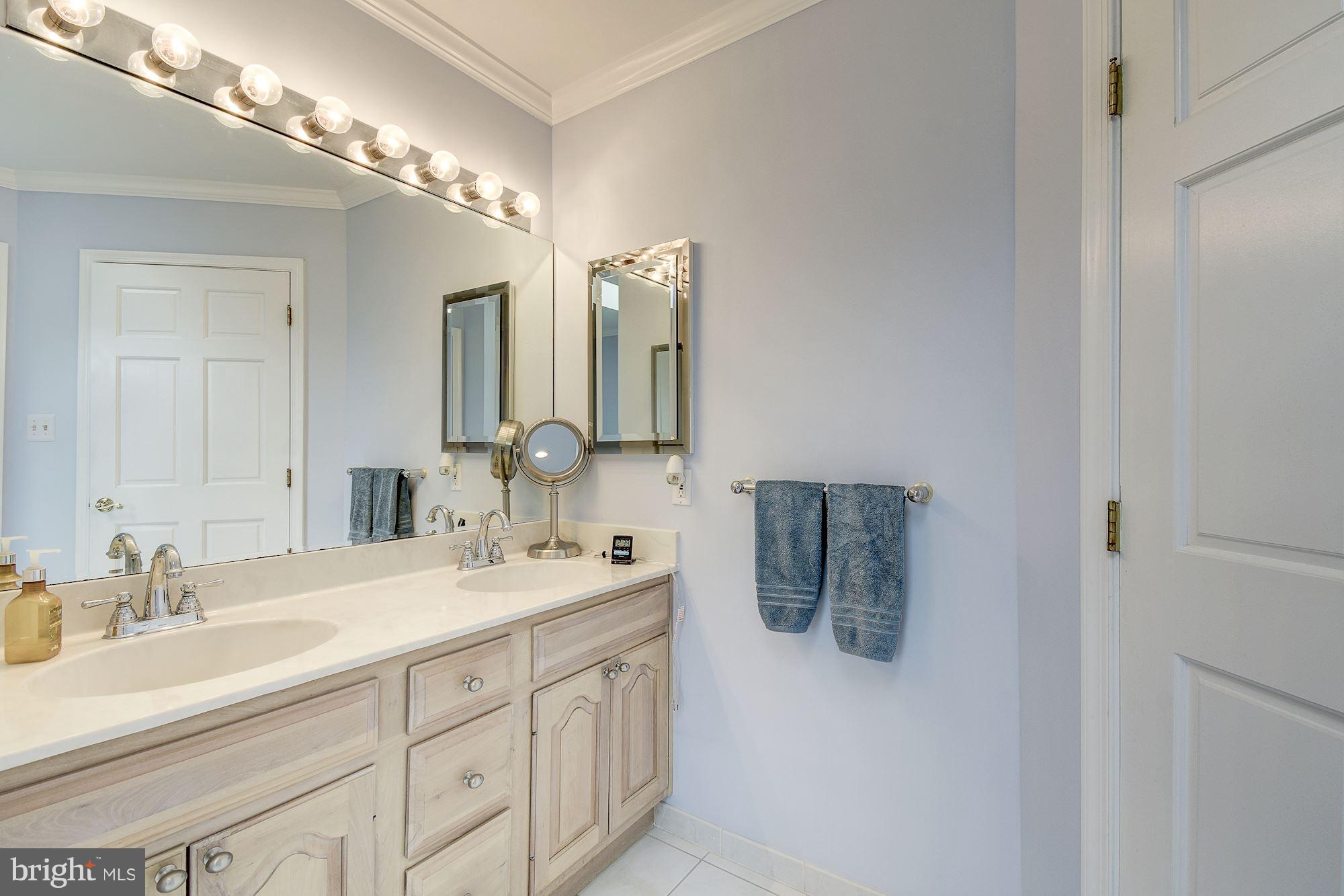 10920 Ward Road Dunkirk, MD 20754 - Photo 28 of 63 a bathroom with a double vanity sink and a mirror