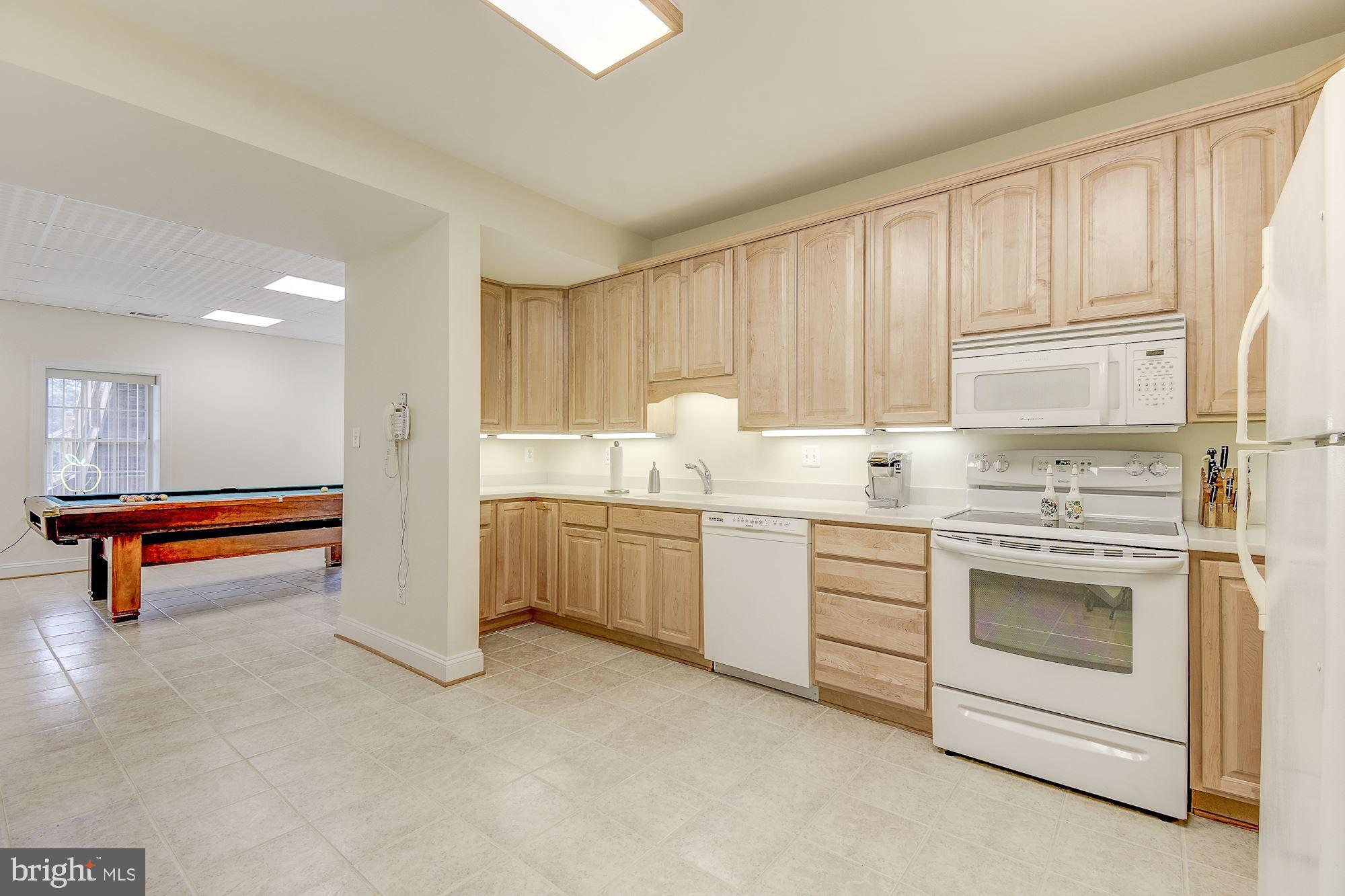 10920 Ward Road Dunkirk, MD 20754 - Photo 40 of 63 a kitchen with stainless steel appliances granite countertop a stove a sink and a refrigerator