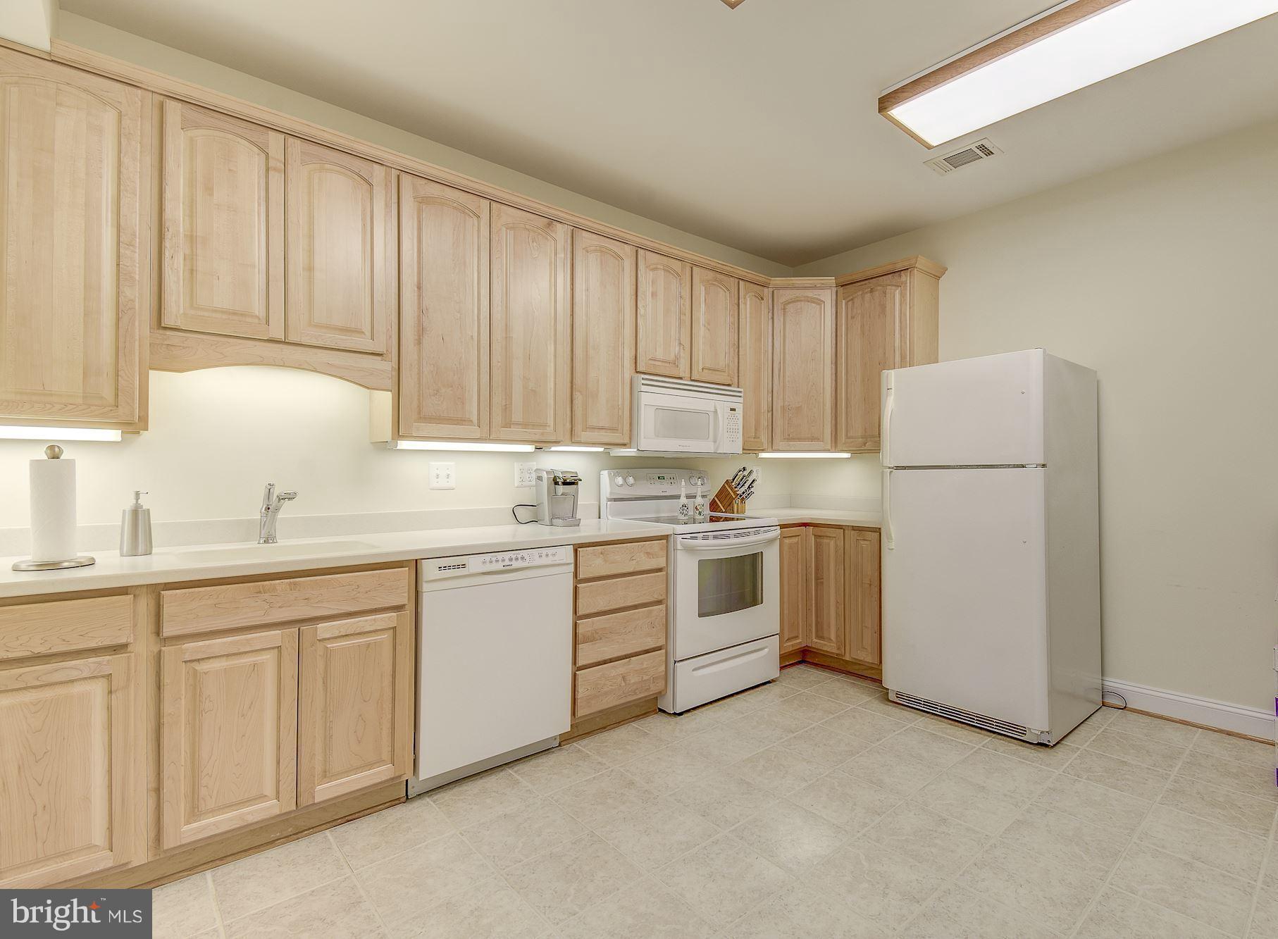 10920 Ward Road Dunkirk, MD 20754 - Photo 41 of 63 a kitchen with white cabinets and white appliances