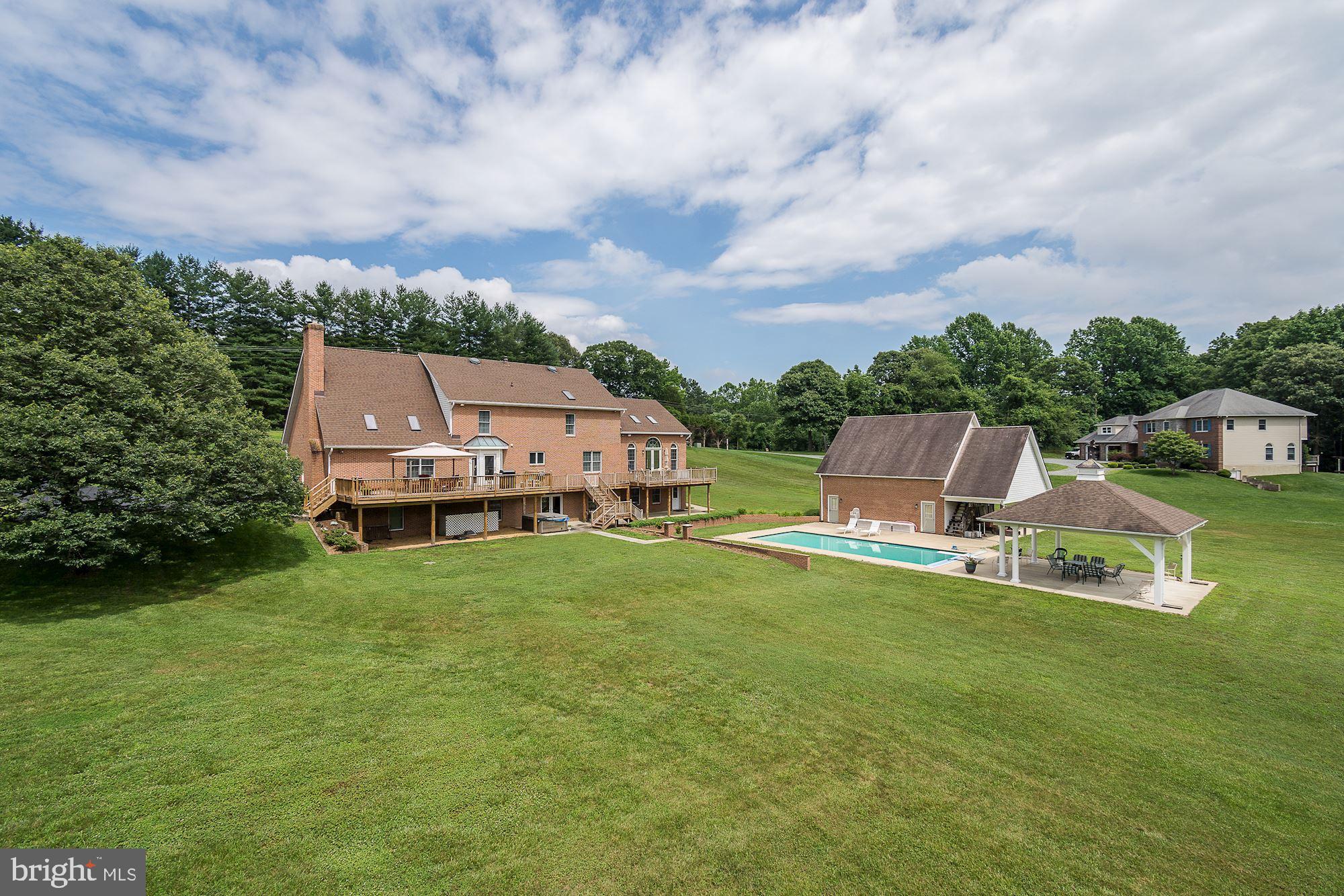 10920 Ward Road Dunkirk, MD 20754 - Photo 6 of 63 an aerial view of a house with swimming pool garden and trees