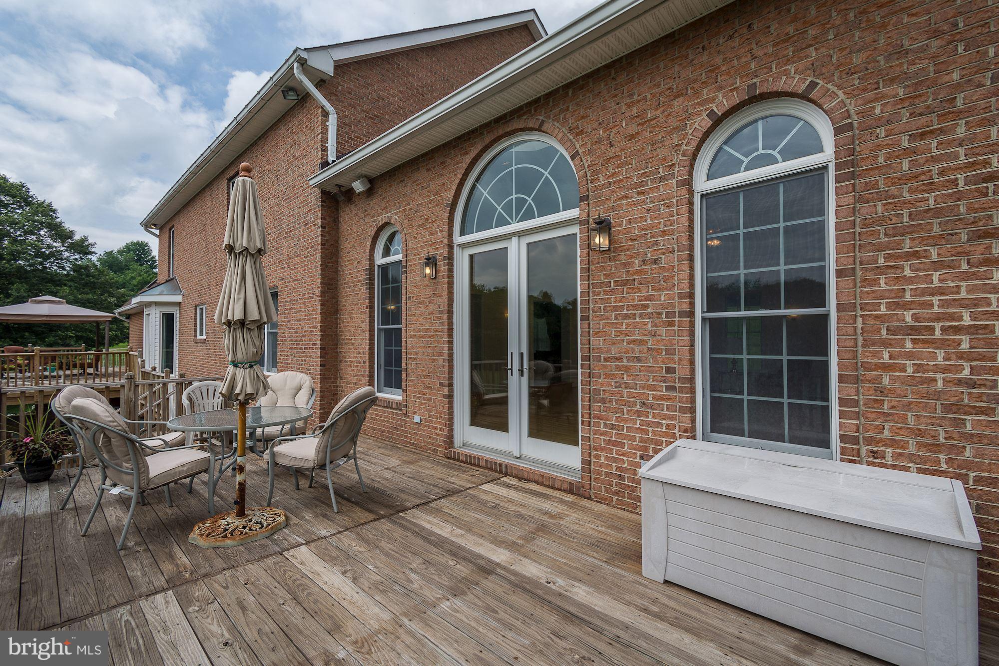 10920 Ward Road Dunkirk, MD 20754 - Photo 55 of 63 a view of a brick house with chairs and table in a patio
