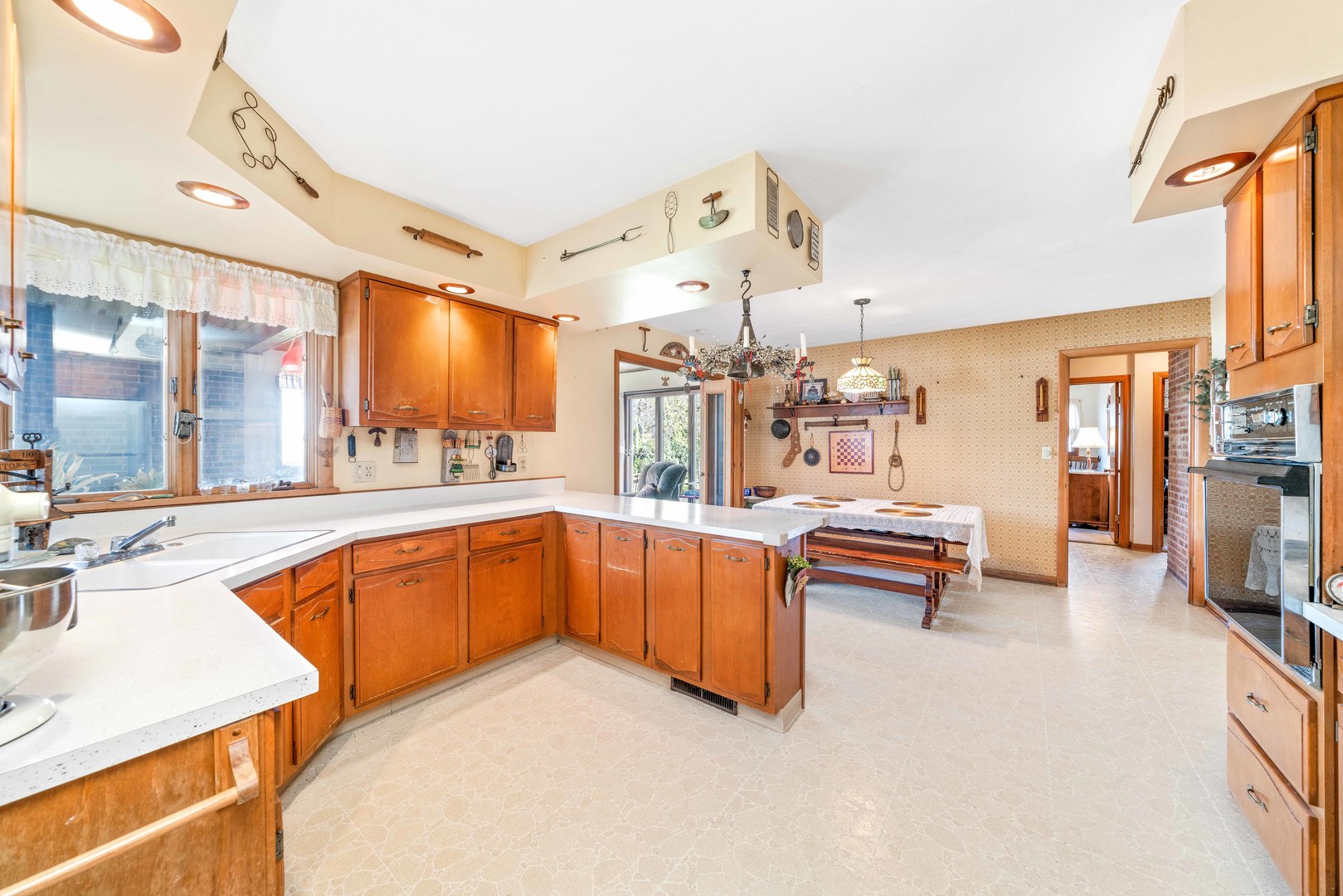 808 Normal Road DeKalb, IL 60115 - Photo 13 of 29 a large white kitchen with a large window and stainless steel appliances