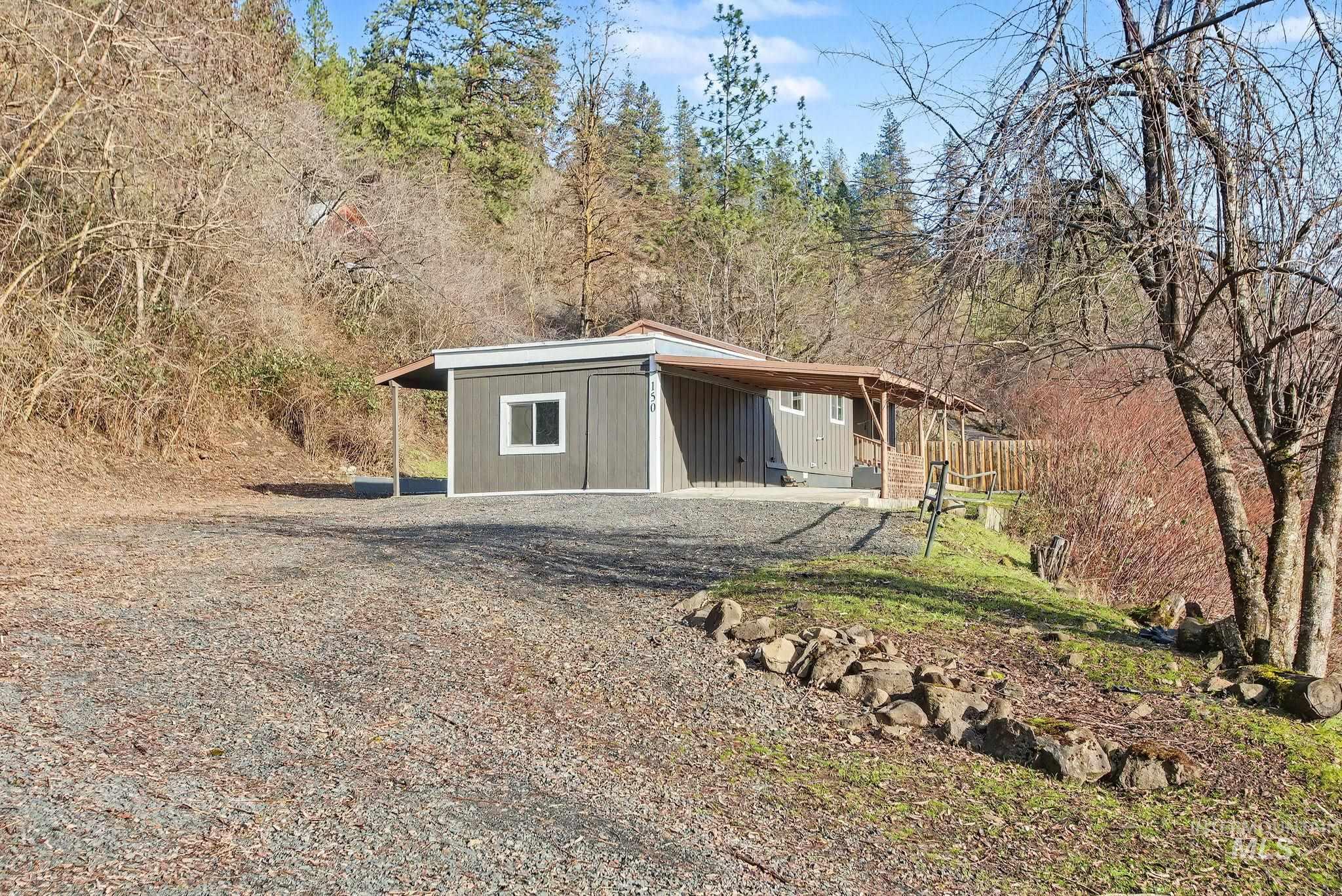 150 Elm Street Orofino, ID 83544 - Photo 35 of 36 Single-story residence featuring gray siding with white trim accents and a covered front porch