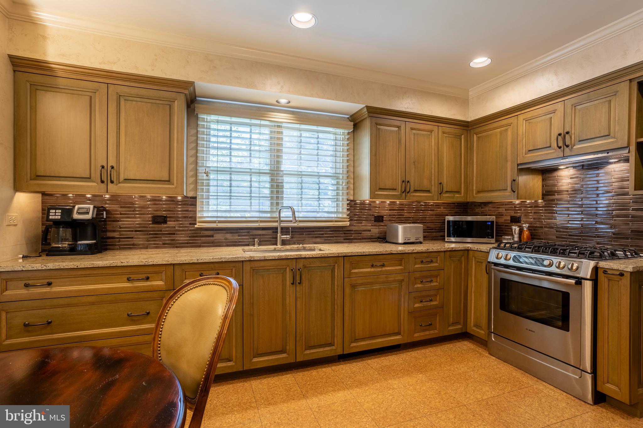 63 Raisin Tree Circle Baltimore, MD 21208 - Photo 15 of 57 a kitchen with stainless steel appliances granite countertop a stove a sink and a microwave