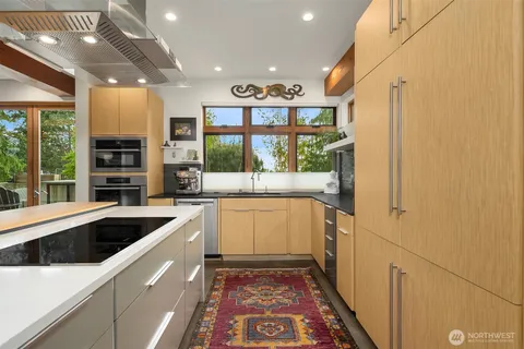 a kitchen with stainless steel appliances granite countertop a refrigerator and a sink