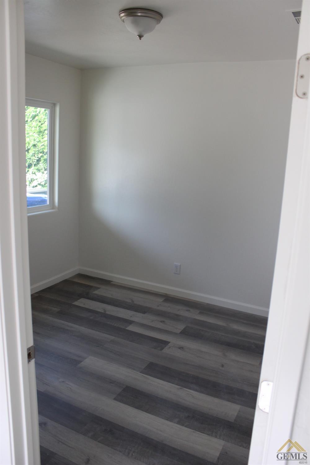 Undisclosed Address Wasco, CA 93280 - Photo 13 of 26 a view of room with window and hardwood floor