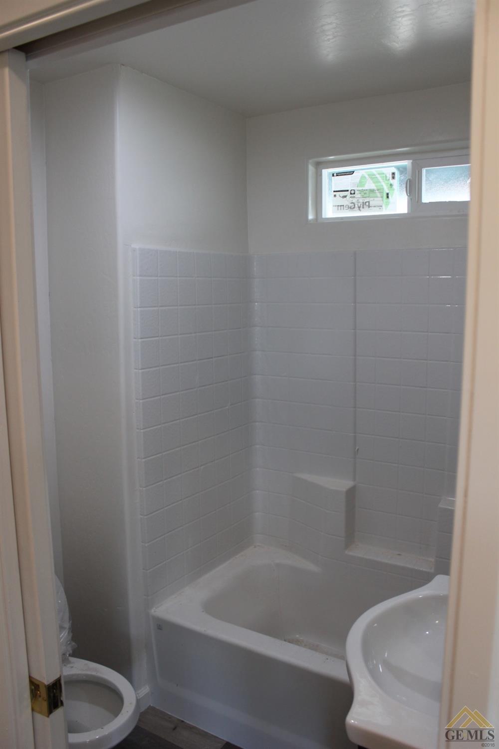 Undisclosed Address Wasco, CA 93280 - Photo 14 of 26 a bathroom with a toilet and a bathtub