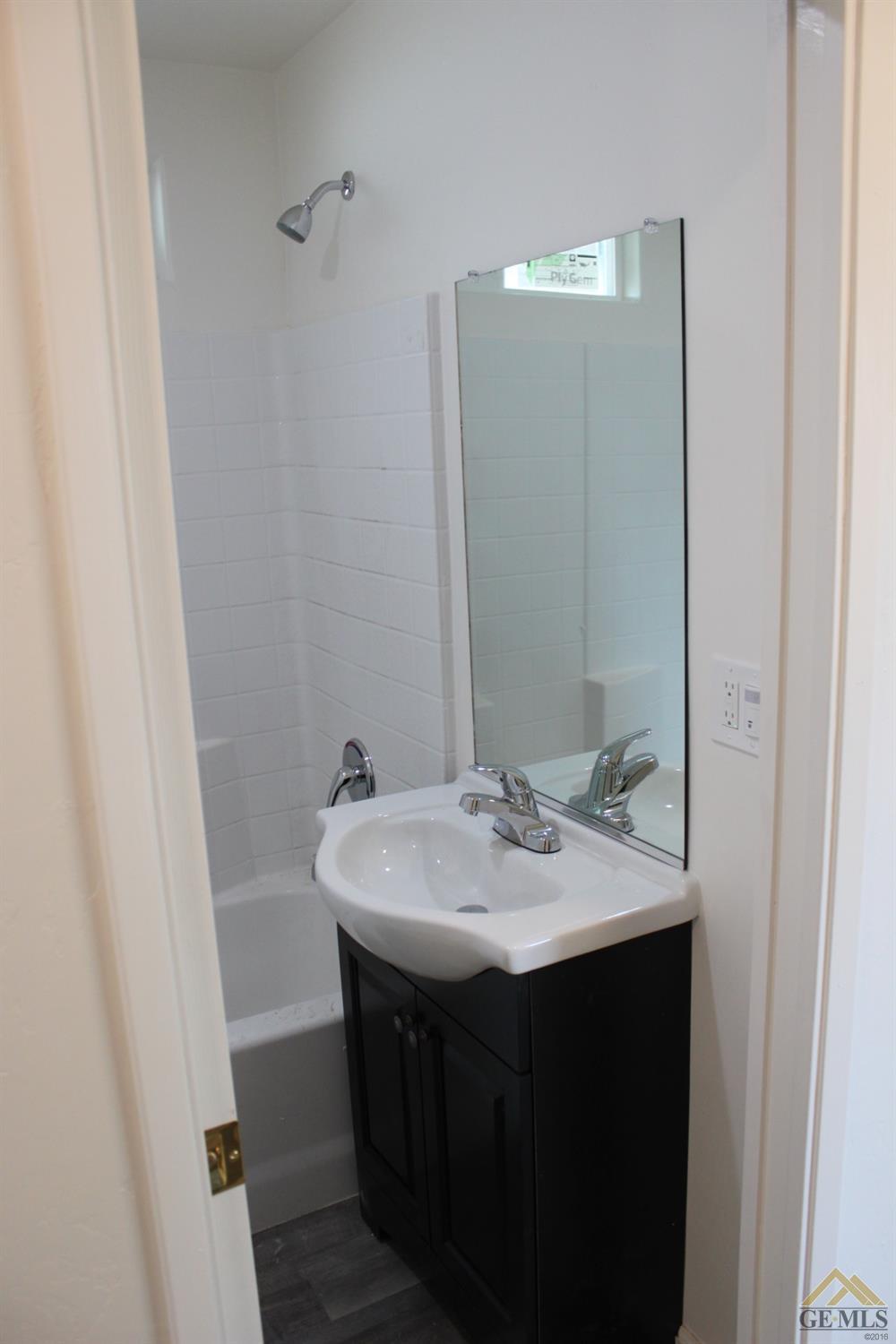 Undisclosed Address Wasco, CA 93280 - Photo 15 of 26 a bathroom with a sink and a mirror