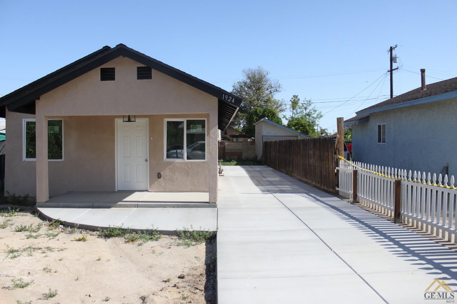 Undisclosed Address Wasco, CA 93280 - Photo 3 of 26 a front view of a house with a porch