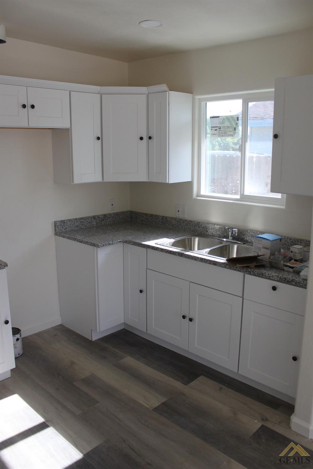 Undisclosed Address Wasco, CA 93280 - Photo 7 of 26 a kitchen with granite countertop white cabinets and a window
