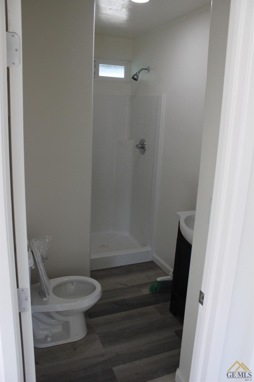 Undisclosed Address Wasco, CA 93280 - Photo 8 of 26 a white toilet sitting next to a shower