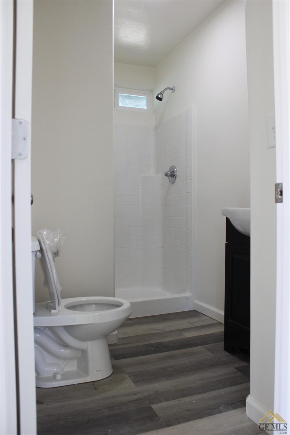 Undisclosed Address Wasco, CA 93280 - Photo 9 of 26 a bathroom with a toilet and a shower