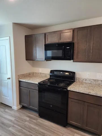 a kitchen with a stove and a microwave