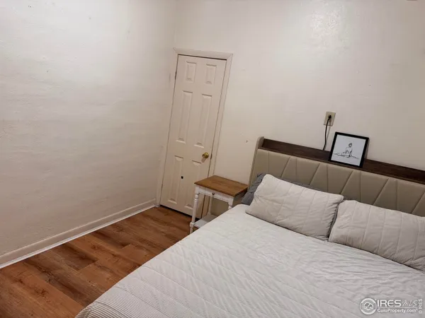 a bedroom with a bed and a night stand