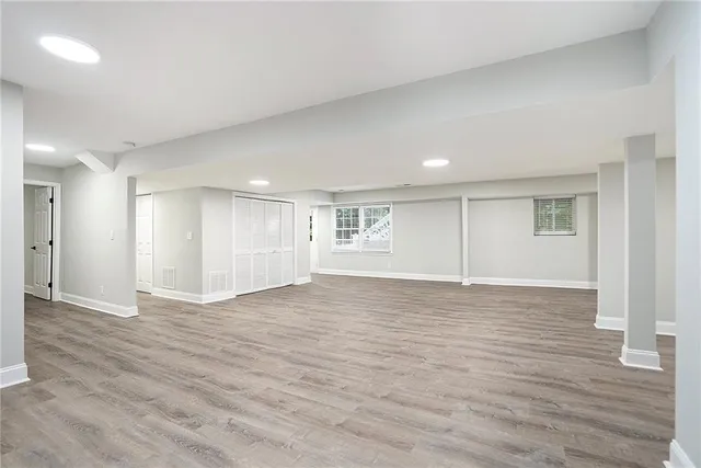 a view of an empty room with wooden floor