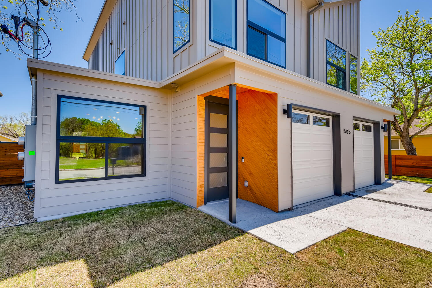 505 Kemp Street Austin, TX 78741 - Photo 5 of 34 The entry brings the personality with warm wood detail, oversized windows, and a sleek modern exterior that sets the tone before you step inside.