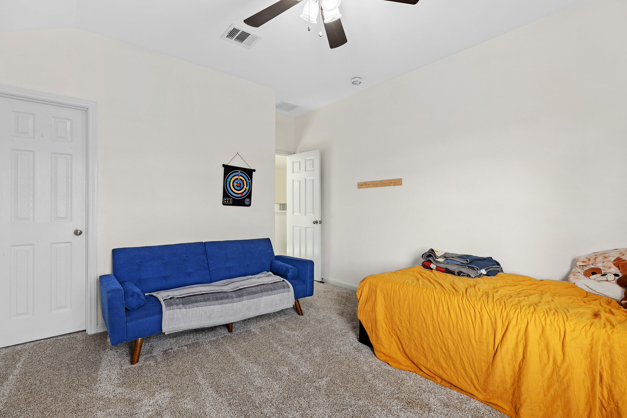 3517 Shiraz Loop Round Rock, TX 78665 - Photo 26 of 40 Carpeted room featuring a ceiling fan with integrated lighting, white six-panel doors, and a wall-mounted wooden rack