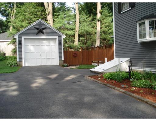 11 Oak Ridge Road Reading, MA 01867 - Photo 12 of 13 a front view of a house with a garden