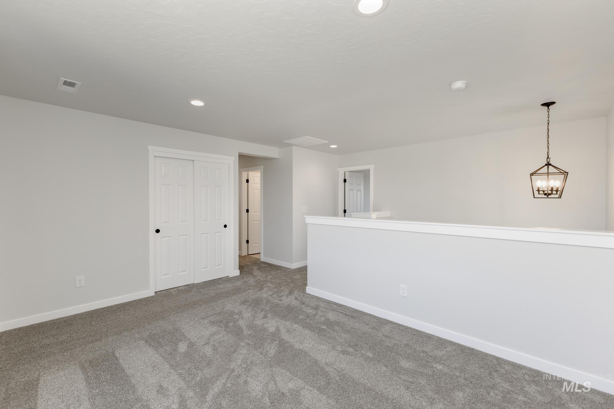 3218 North Waterbrook Way Star, ID 83669 - Photo 15 of 27 Empty room featuring carpet floors, recessed lighting, and a chandelier