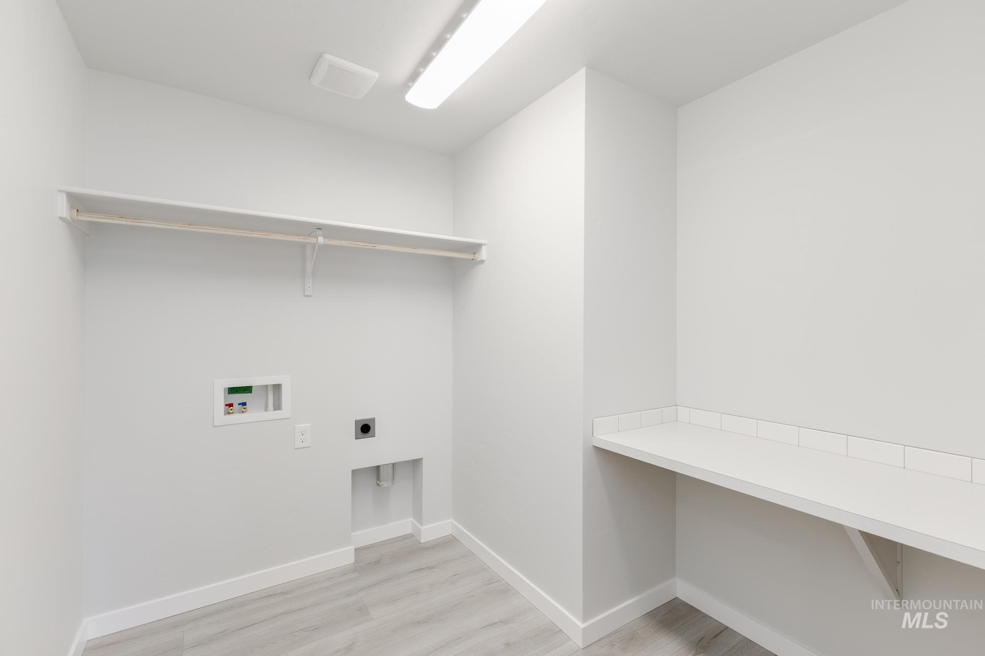 3218 North Waterbrook Way Star, ID 83669 - Photo 19 of 27 Washroom with hookup for an electric dryer, light wood-style floors, and washer hookup