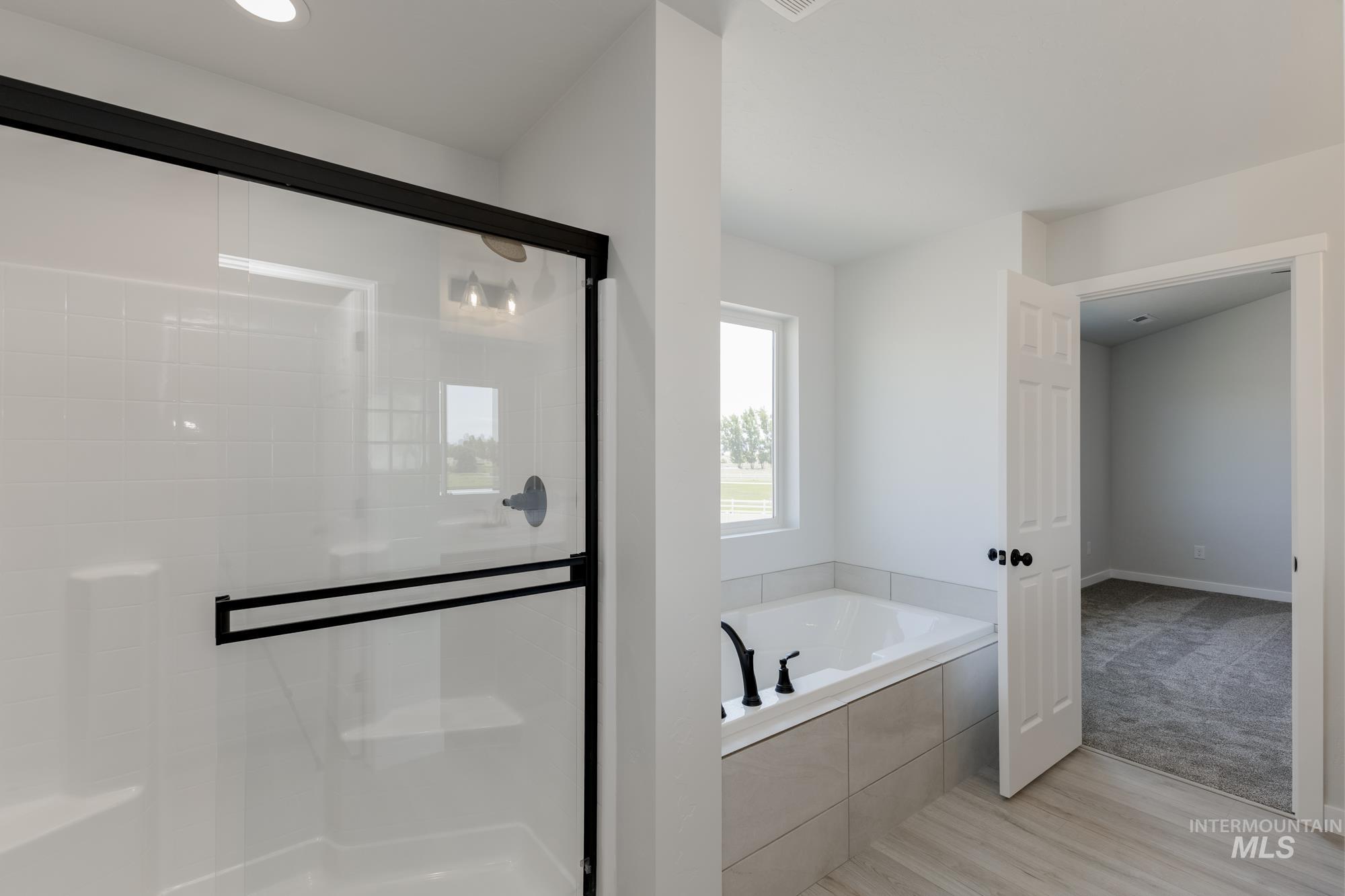 3218 North Waterbrook Way Star, ID 83669 - Photo 25 of 27 Bathroom featuring a stall shower, a bath, light wood-style floors, and recessed lighting