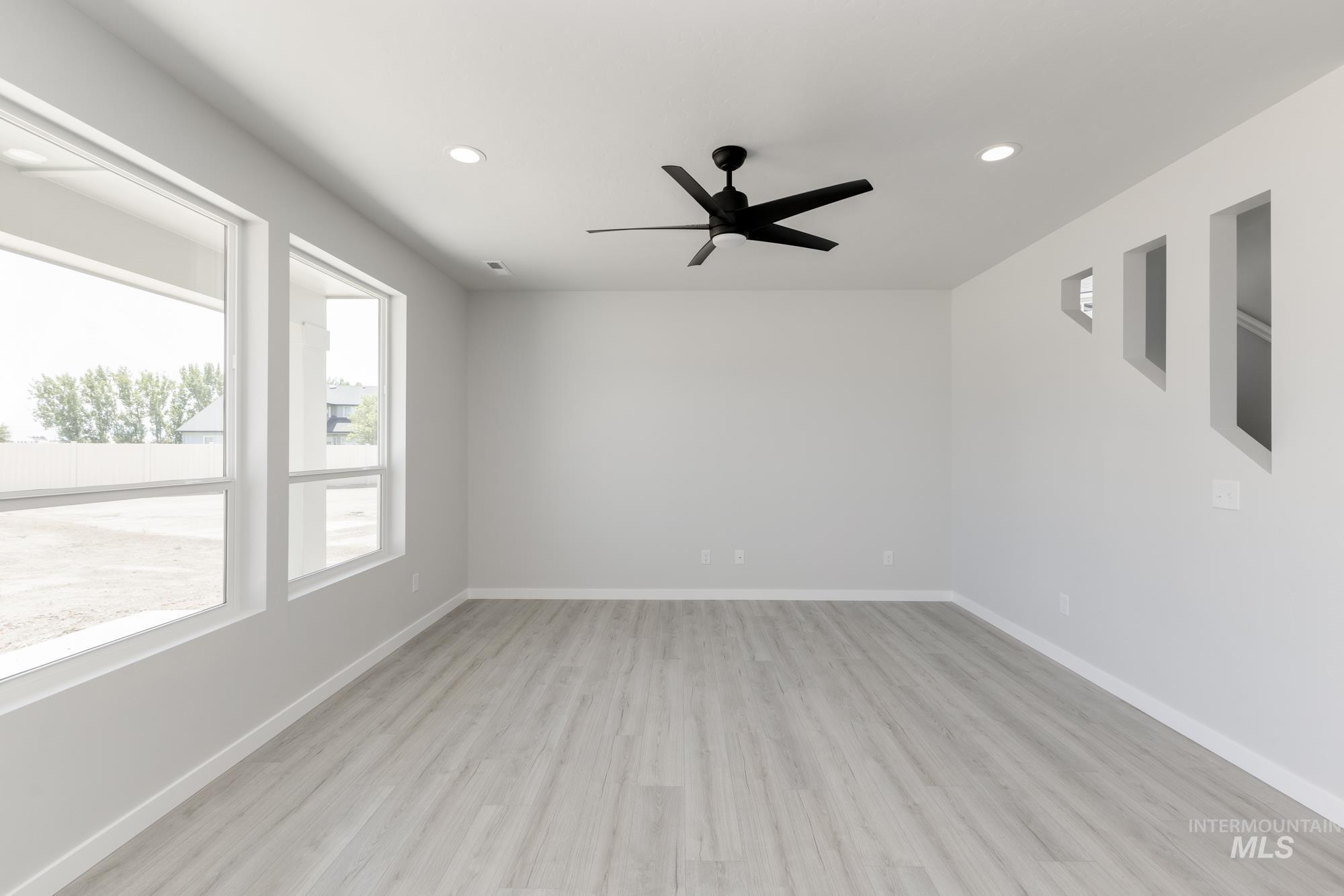 3218 North Waterbrook Way Star, ID 83669 - Photo 7 of 27 Unfurnished room with light wood-type flooring, recessed lighting, and a ceiling fan