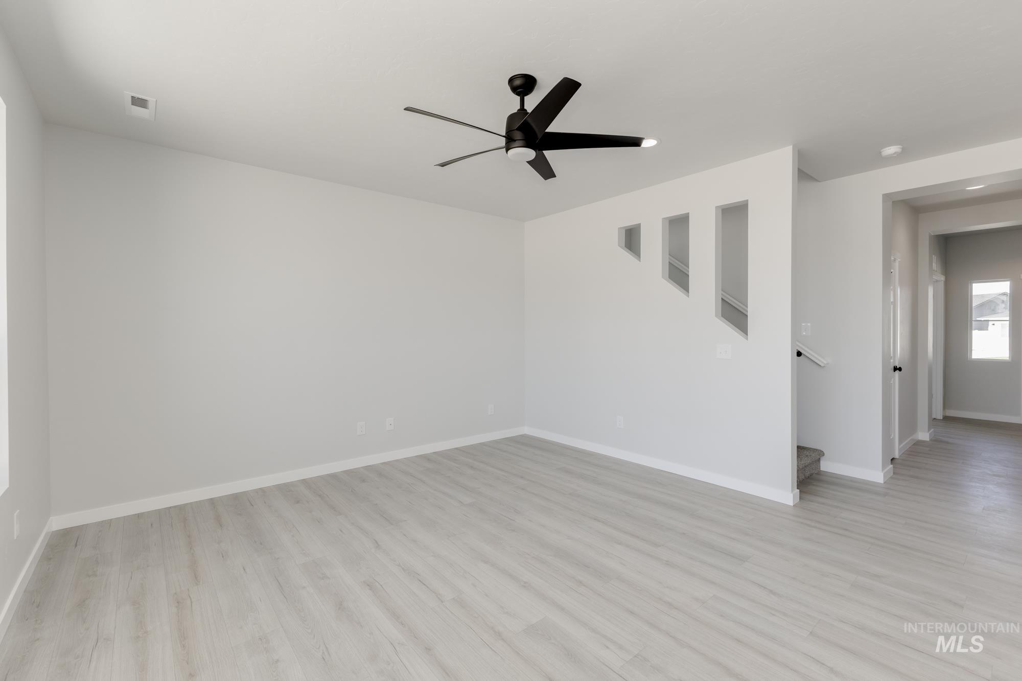 3218 North Waterbrook Way Star, ID 83669 - Photo 8 of 27 Empty room with light wood finished floors, ceiling fan, and recessed lighting