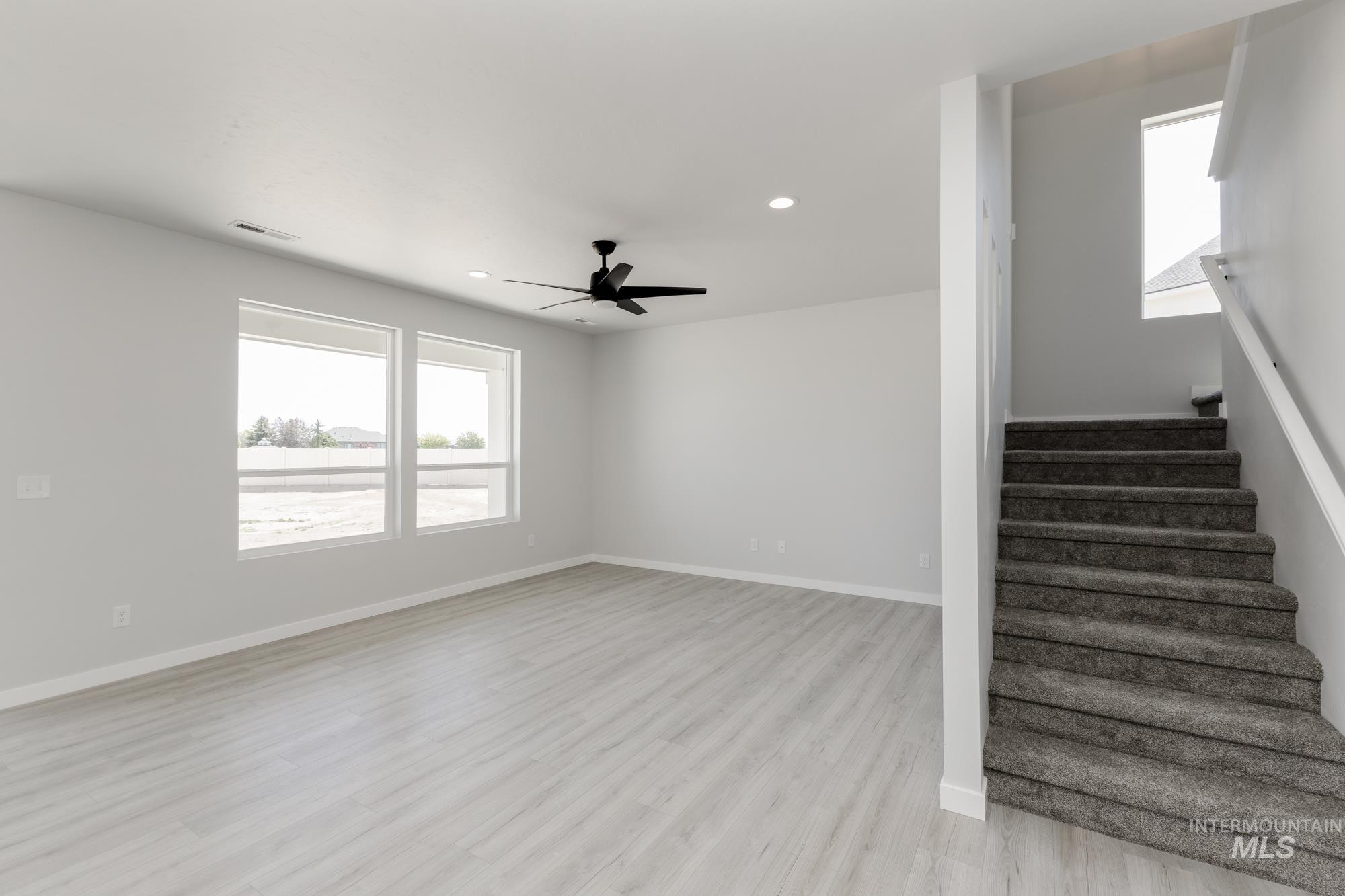 3218 North Waterbrook Way Star, ID 83669 - Photo 9 of 27 Staircase with wood finished floors, recessed lighting, and ceiling fan