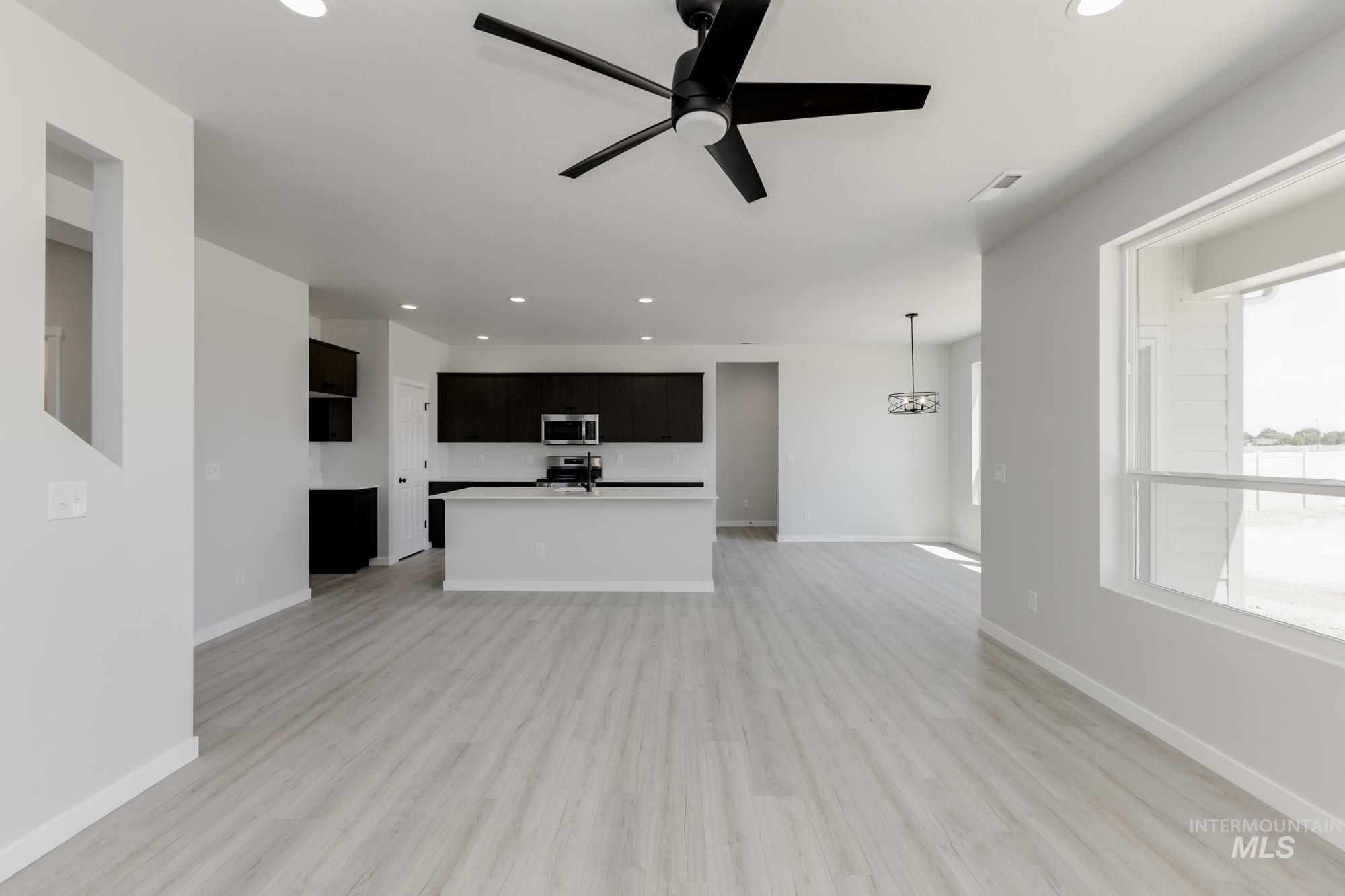 3218 North Waterbrook Way Star, ID 83669 - Photo 10 of 27 Unfurnished living room with light wood-style flooring, recessed lighting, and ceiling fan