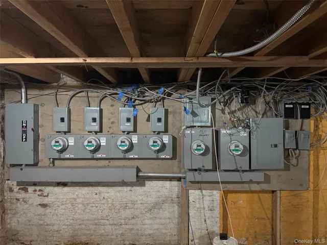 a room with water heater and wooden cabinets