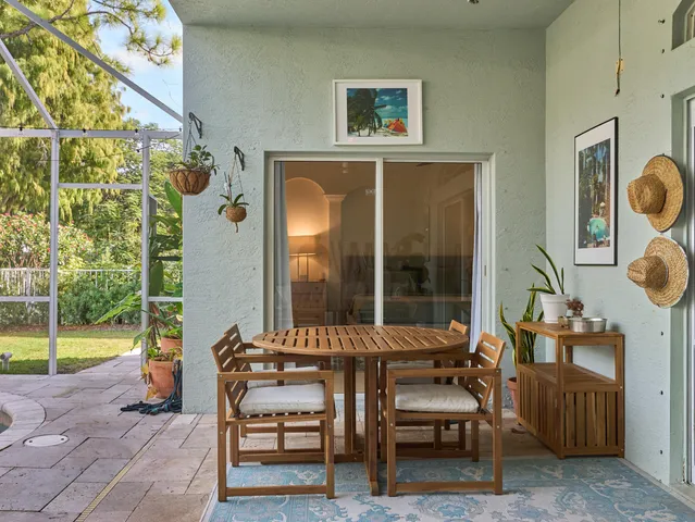 a view of a chairs and table in a back yard