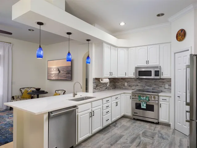 a kitchen with a sink stove and microwave