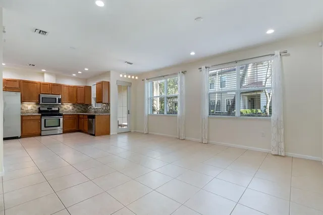 a view of kitchen with refrigerator and window