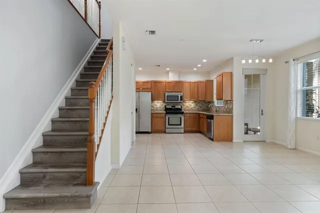 a view of kitchen with wooden floor and electronic appliances