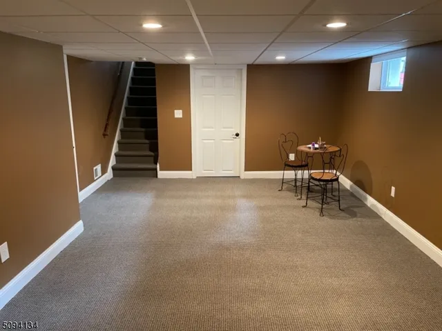 an empty room with wooden floor and furniture
