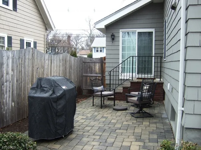 a couple of chairs sitting in front of a house