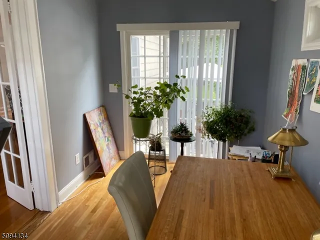 a view of a dining room with furniture and a potted plant