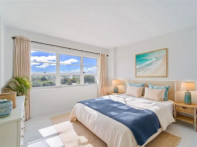 a bedroom with a large bed and a large window