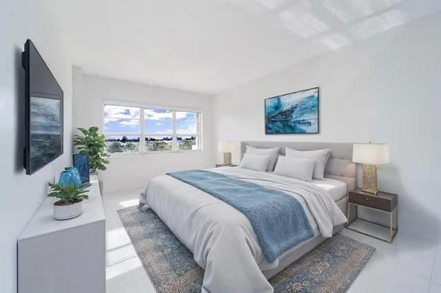 a bedroom with a large bed and a potted plant