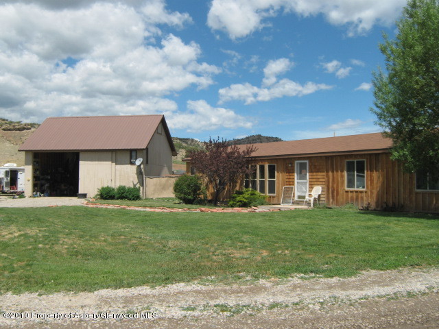 2920 County Road 233 Rifle, CO 81650 - Photo 13 of 13 a front view of a house with a garden