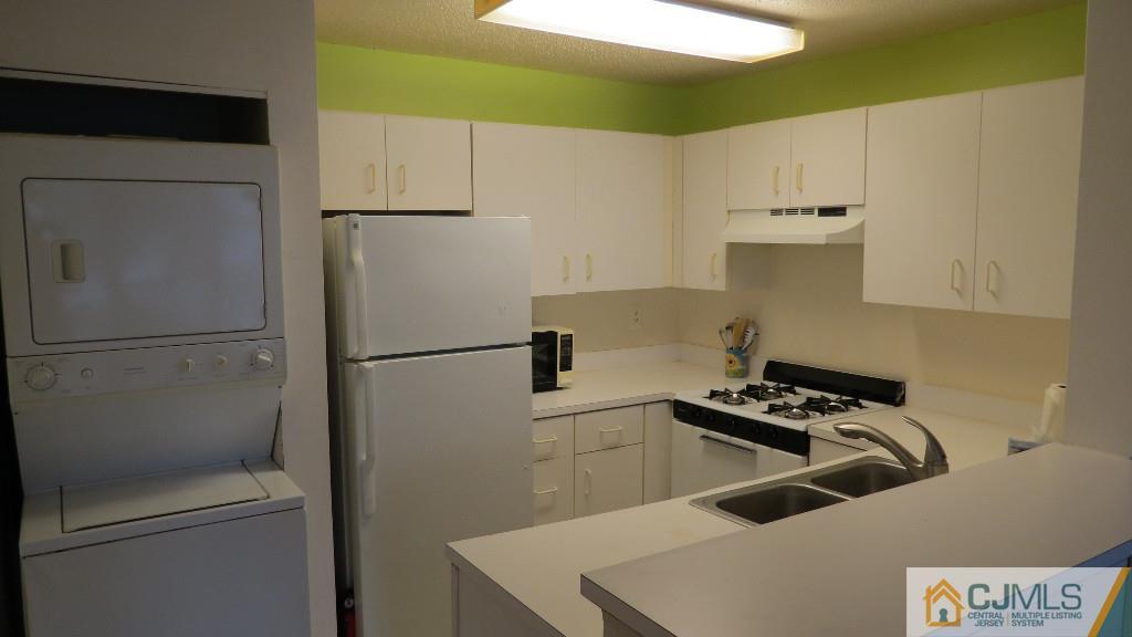 216 Edpas Road New Brunswick, NJ 08901 - Photo 11 of 18 a kitchen with a refrigerator and a stove