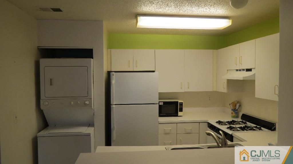216 Edpas Road New Brunswick, NJ 08901 - Photo 12 of 18 a kitchen with a refrigerator and a sink