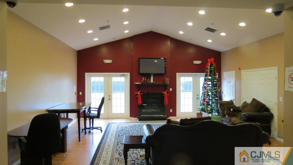 216 Edpas Road New Brunswick, NJ 08901 - Photo 16 of 18 a living room with furniture and a potted plant
