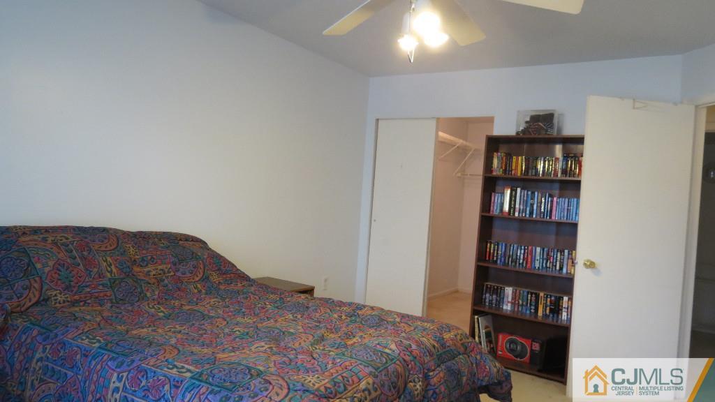 216 Edpas Road New Brunswick, NJ 08901 - Photo 7 of 18 a bedroom with a bed and a book shelf