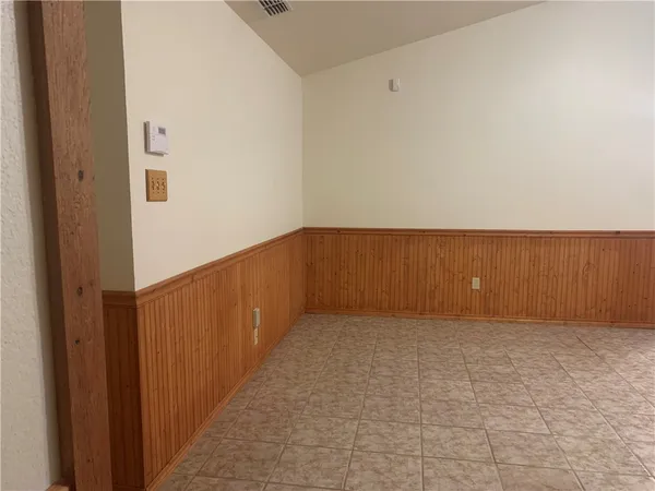 a backyard of a house with table and chairs