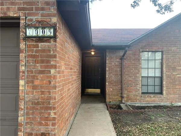 a view of a brick house with a large window