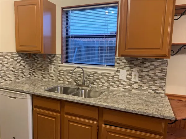a kitchen with a sink and cabinets