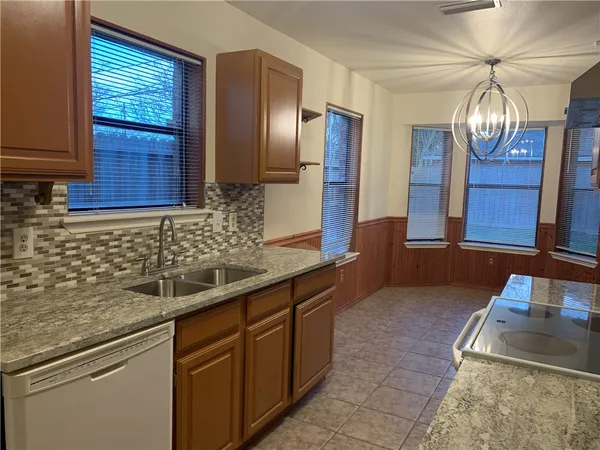 a kitchen with stainless steel appliances granite countertop a sink and cabinets